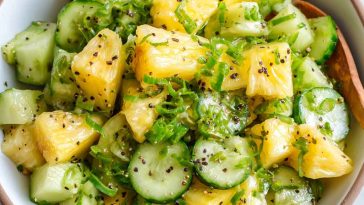 Pineapple cucumber salad with fresh herbs in a bowl