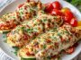 Keto Chicken Parmesan Zucchini Boats with tender chicken, melted cheese, and marinara sauce baked in zucchini halves.