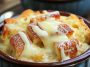 Classic old fashioned bread pudding topped with creamy vanilla sauce, served warm in a rustic dish.