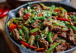 Spicy cumin lamb stir fry with peppers and onions in a wok
