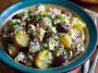 Colorful olive Greek potato salad with red potatoes, Kalamata olives, cucumbers, tomatoes, and feta cheese tossed in lemon‑herb dressing.
