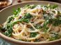 Creamy lemon ricotta pasta with fresh arugula, inspired by Stanley Tucci, served in a bowl with a light, zesty sauce and grated cheese.