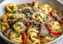 Creamy crock pot cheesesteak tortellini with tender beef, melted cheese, and tender pasta in a savory sauce.