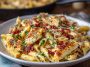 Creamy crack chicken penne pasta made with tender chicken, crispy bacon, cheddar cheese, and a rich ranch-flavored sauce, garnished with parsley.
