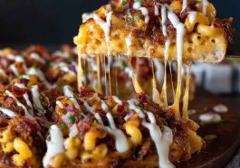“A BBQ pulled pork pizza topped with creamy mac ’n’ cheese, crispy bacon, and melted cheese on a golden crust.”