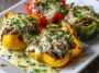 “Bell peppers stuffed with Philly cheesesteak filling of beef, onions, and melted cheese, served on a tray.”