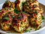 Garlic Parmesan Chicken Meatloaves with golden-brown crust, served with roasted vegetables and garnished with fresh parsley.