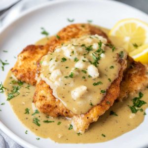Golden chicken francese cutlets coated in a light egg batter, pan‑fried, and served with lemon butter sauce.