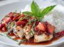 Strawberry basil chicken garnished with fresh basil leaves on a plate