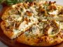 A golden-brown roasted garlic white chicken pizza topped with melted mozzarella, tender chicken pieces, and fresh herbs on a crispy crust.
