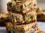 Golden brown butter pistachio cookie bars drizzled with honey and topped with chopped pistachios.