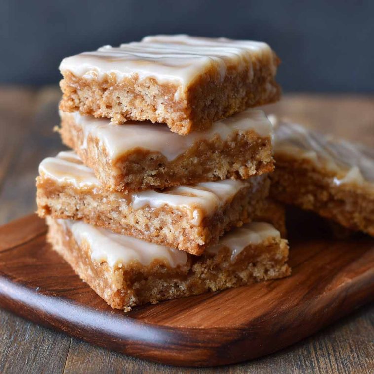 Crispy Homemade Maple Bars with Sweet Maple Glaze, golden-brown bars drizzled with sweet maple icing, served on a plate.