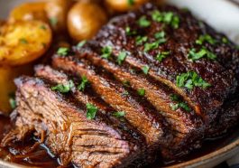 Juicy slow cooker brisket sliced with rich gravy, served with roasted vegetables.
