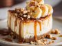 Banana Caramel Nut Cheesecake topped with caramel drizzle and crunchy nuts on a dessert plate