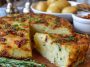 Savory German potato cake with golden crust, herbs, and sausage slices served on a rustic wooden board