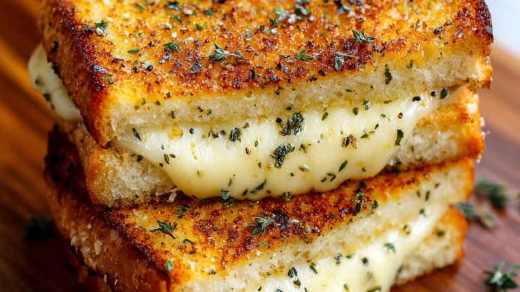 “Golden grilled cheese sandwich made with garlic bread, oozing melted cheese, served on a wooden board.”