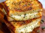 “Golden grilled cheese sandwich made with garlic bread, oozing melted cheese, served on a wooden board.”