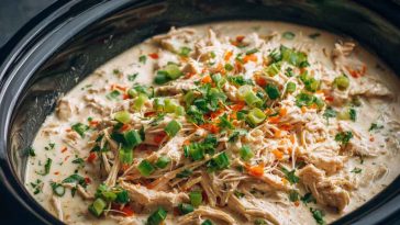 “Creamy ranch chicken cooked in a crock pot, served over rice with fresh parsley garnish.”