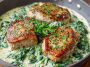 Boneless pork chops in creamy garlic spinach sauce served in a skillet