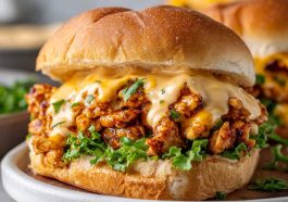 Cajun chicken sloppy joes topped with creamy cheese sauce served on a toasted bun.