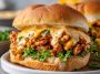 Cajun chicken sloppy joes topped with creamy cheese sauce served on a toasted bun.