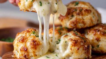 Golden biscuit bombs stuffed with melted mozzarella cheese, brushed with garlic butter and herbs.