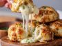 Golden biscuit bombs stuffed with melted mozzarella cheese, brushed with garlic butter and herbs.