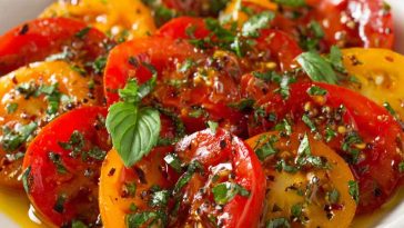 Marinated tomatoes with herbs, garlic, and olive oil in a fresh, flavorful dressing.