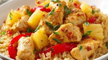 Pineapple chicken and rice with tender chicken, sweet pineapple chunks, and fluffy rice in a savory sauce.