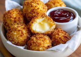 Air fried Babybel cheese with a crispy golden coating and melted cheese center.