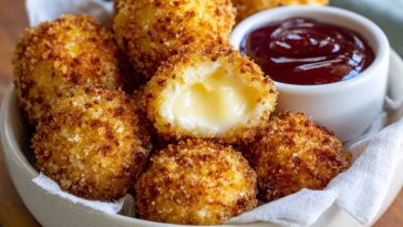 Air fried Babybel cheese with a crispy golden coating and melted cheese center.