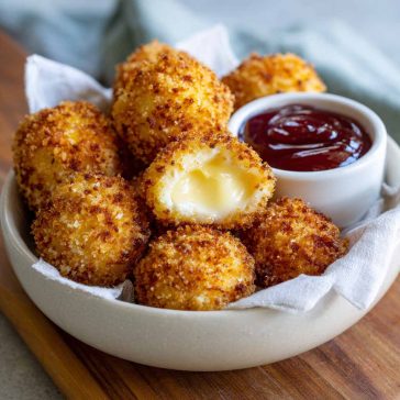 Air fried Babybel cheese with a crispy golden coating and melted cheese center.