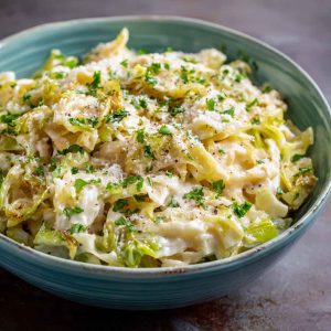 Creamy garlic Alfredo sauce coating tender sautéed cabbage in a rich and comforting dish.