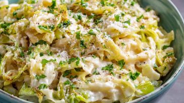 Creamy garlic Alfredo sauce coating tender sautéed cabbage in a rich and comforting dish.