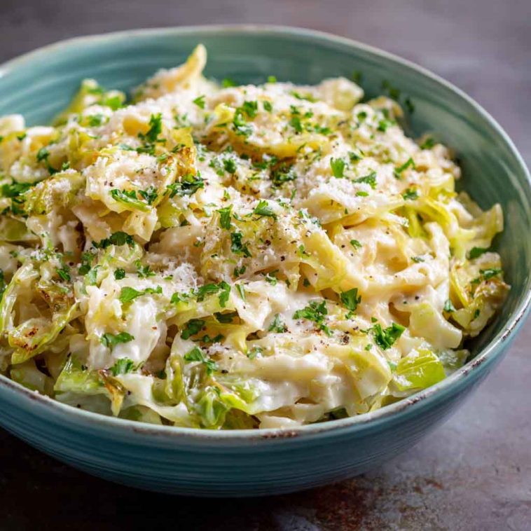 Creamy garlic Alfredo sauce coating tender sautéed cabbage in a rich and comforting dish.
