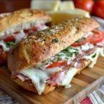 Toasted Italian grinder sandwiches filled with deli meats, melted cheese, and crispy bread.