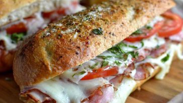 Toasted Italian grinder sandwiches filled with deli meats, melted cheese, and crispy bread.