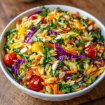 Colorful orzo salad with fresh vegetables in a light, zesty dressing.