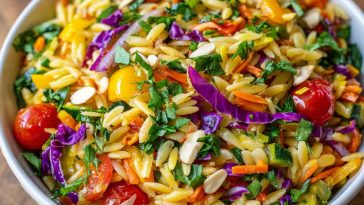 Colorful orzo salad with fresh vegetables in a light, zesty dressing.