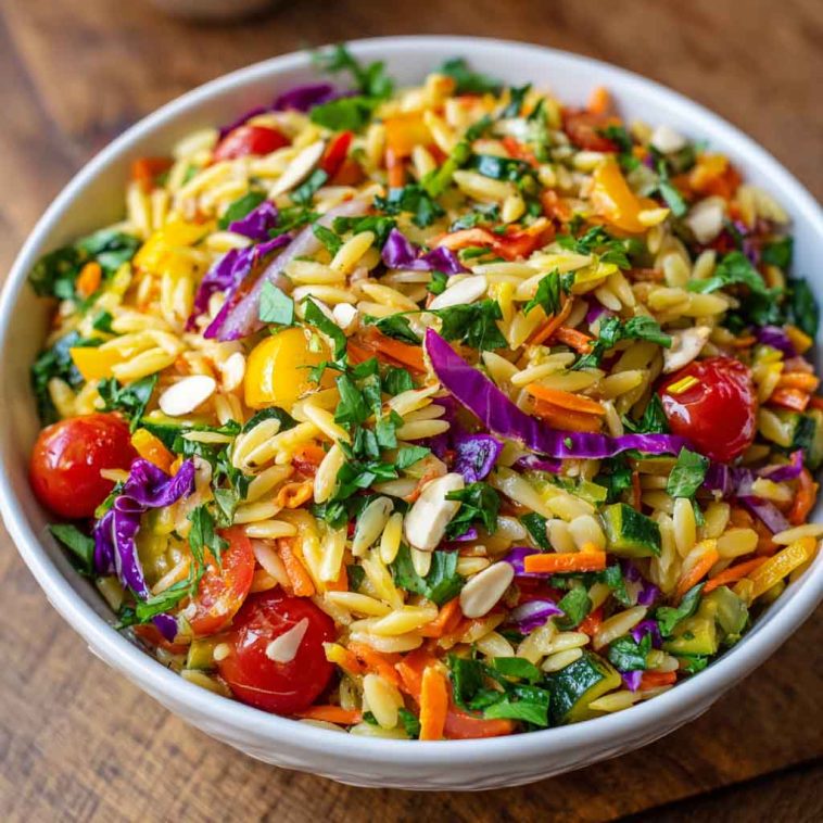 Colorful orzo salad with fresh vegetables in a light, zesty dressing.