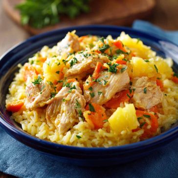 Pineapple chicken and rice cooked in one pan with a sweet and savory glaze.