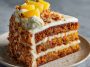 A moist Hawaiian carrot pineapple cake topped with cream cheese frosting, garnished with crushed pineapple and shredded coconut on a rustic cake stand.