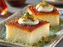 Moist Turkish revani cake soaked in sweet syrup and topped with coconut or pistachios.