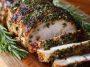 Herb crusted pork loin roast sliced and served with a golden crust and juicy interior.