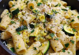 Rigatoni pasta with zucchini, lemon sauce, and Parmesan cheese served in a bowl