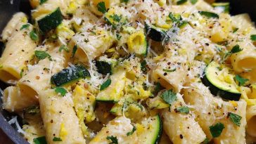 Rigatoni pasta with zucchini, lemon sauce, and Parmesan cheese served in a bowl