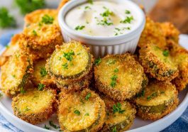 Crispy air fryer fried pickles coated in seasoned breading and served with dipping sauce.