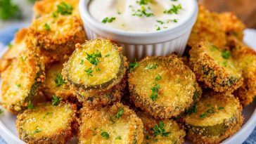 Crispy air fryer fried pickles coated in seasoned breading and served with dipping sauce.
