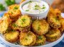 Crispy air fryer fried pickles coated in seasoned breading and served with dipping sauce.