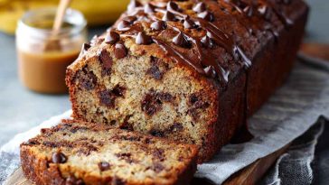 Moist chocolate chip banana bread with sliced bananas and melted chocolate chips throughout.